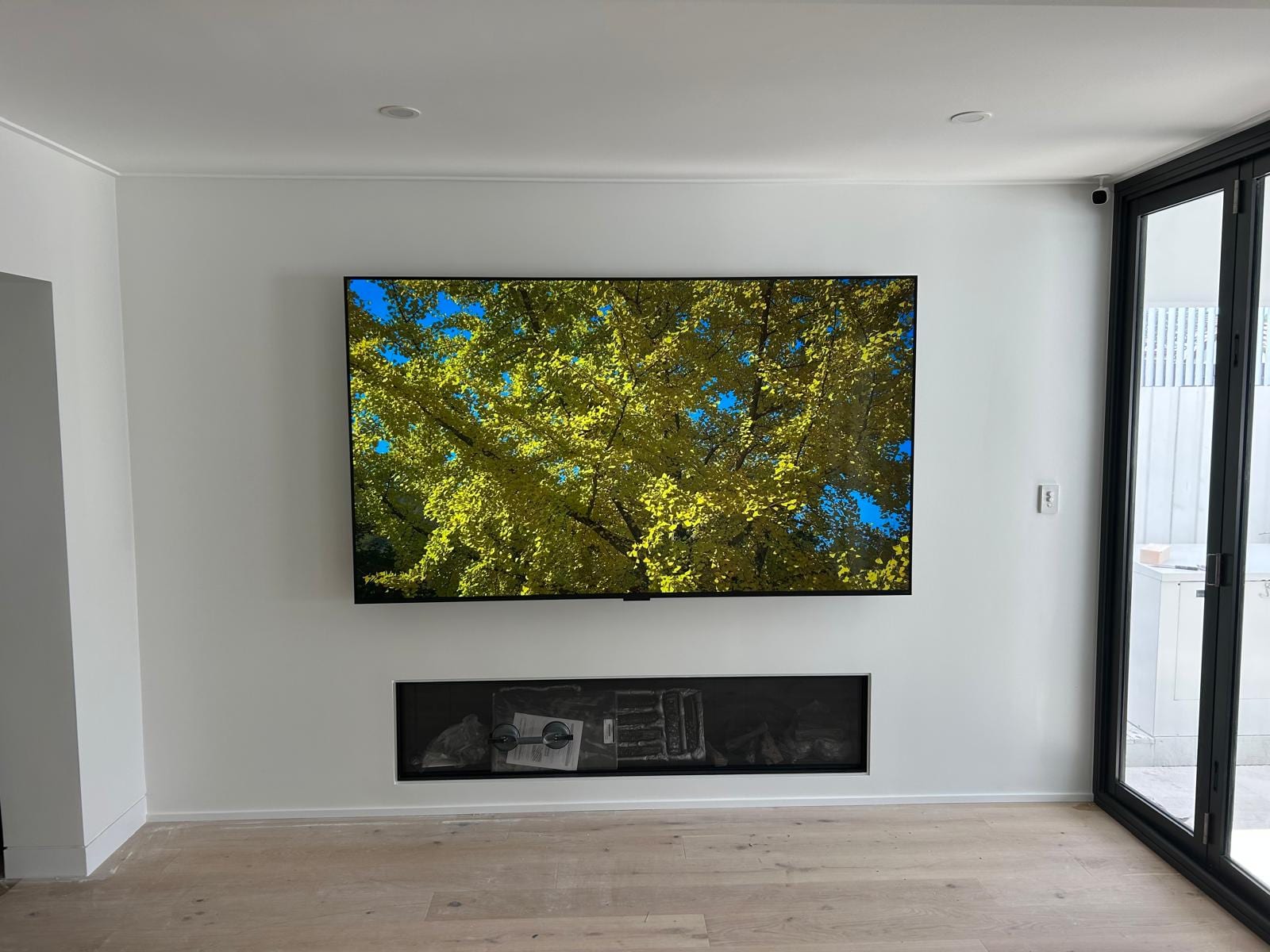 Living area fit-out with wall-mounted TV feature wall